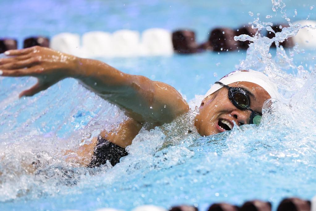 A Texas A&M swimmer comes up for air during a race