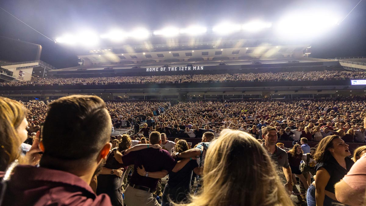 A large crowd of Aggies fills Kyle Field at midnight before a football game.