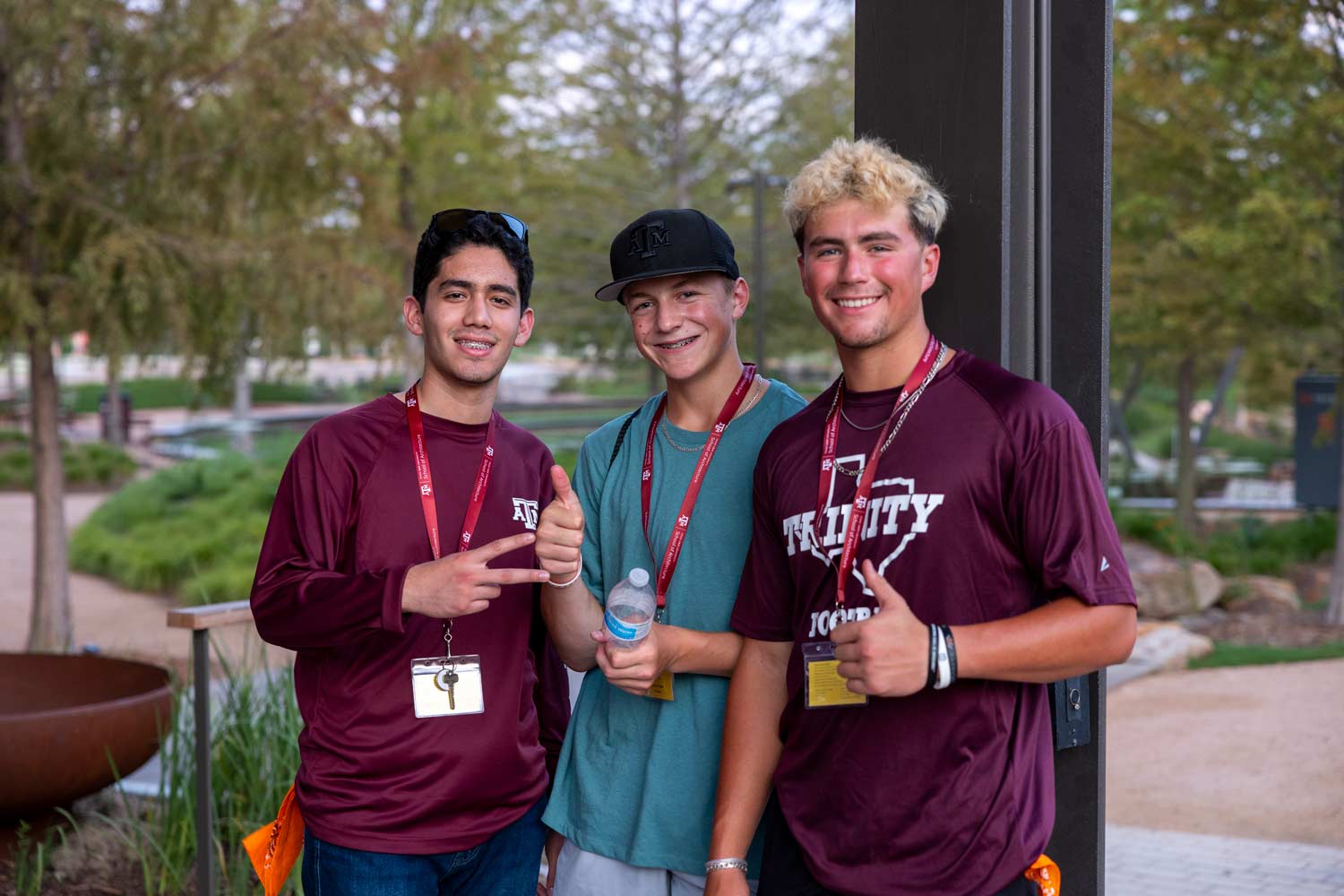 Three high school students posing for a photo at Aggie Park during Camp ARCH