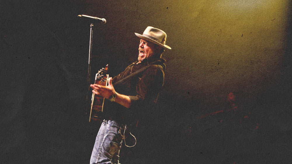 Pat Green with a guitar singing on stage